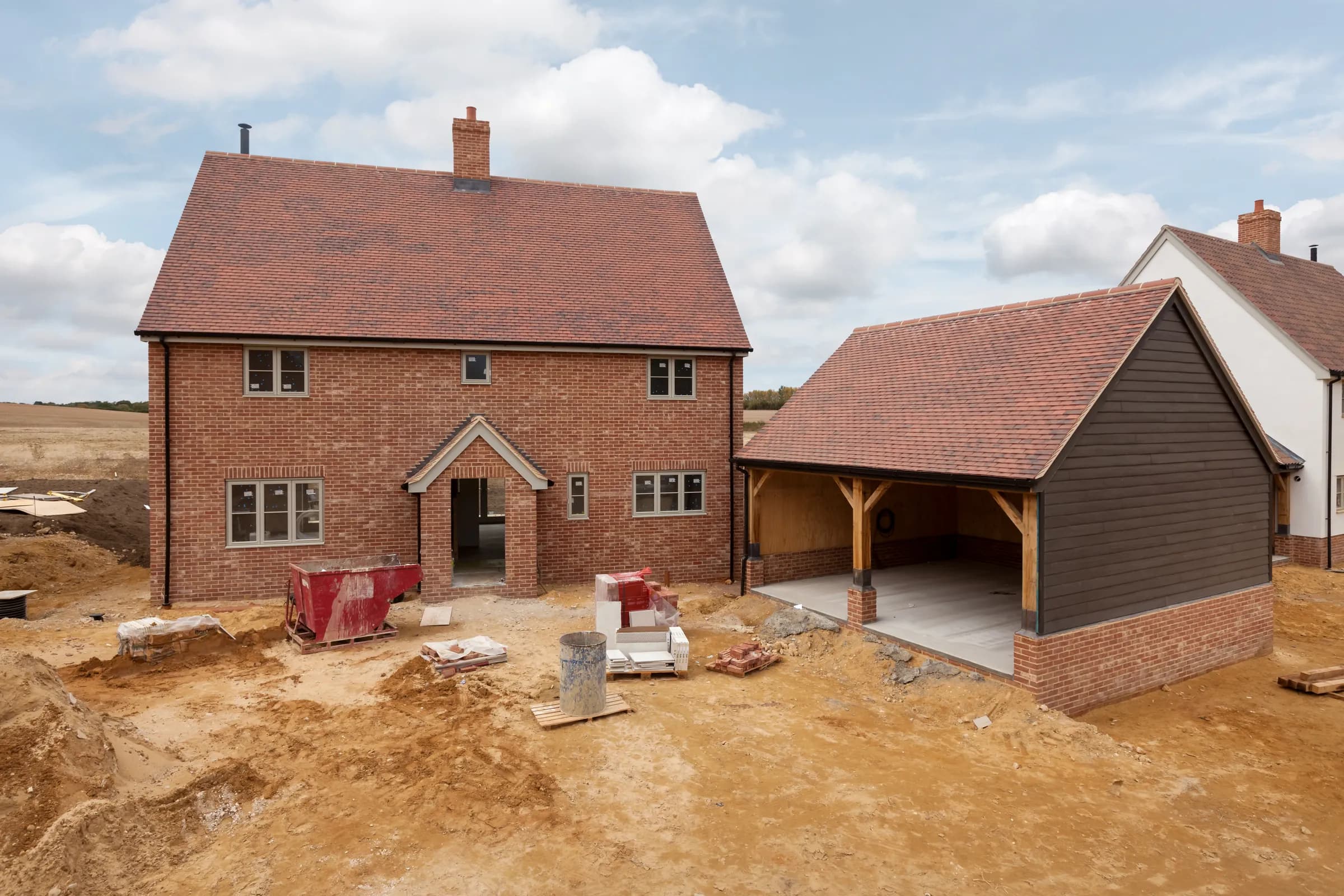 Completed tiled roofs on new-build brick houses